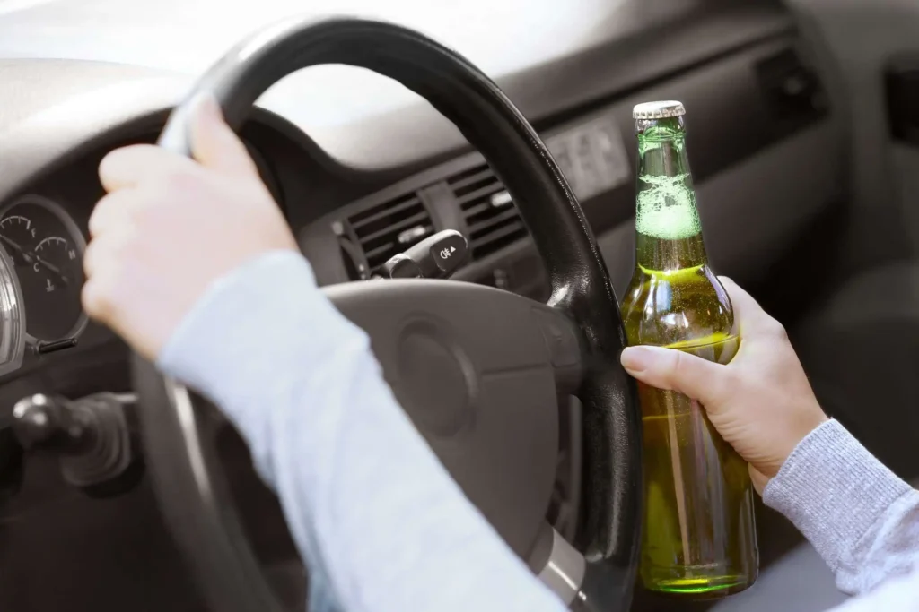 man-holding-bear-bottle-while-driving-which-cause-car accident-in-scotland